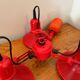 Three-lamp suspension in Memphis design style in red metal.
