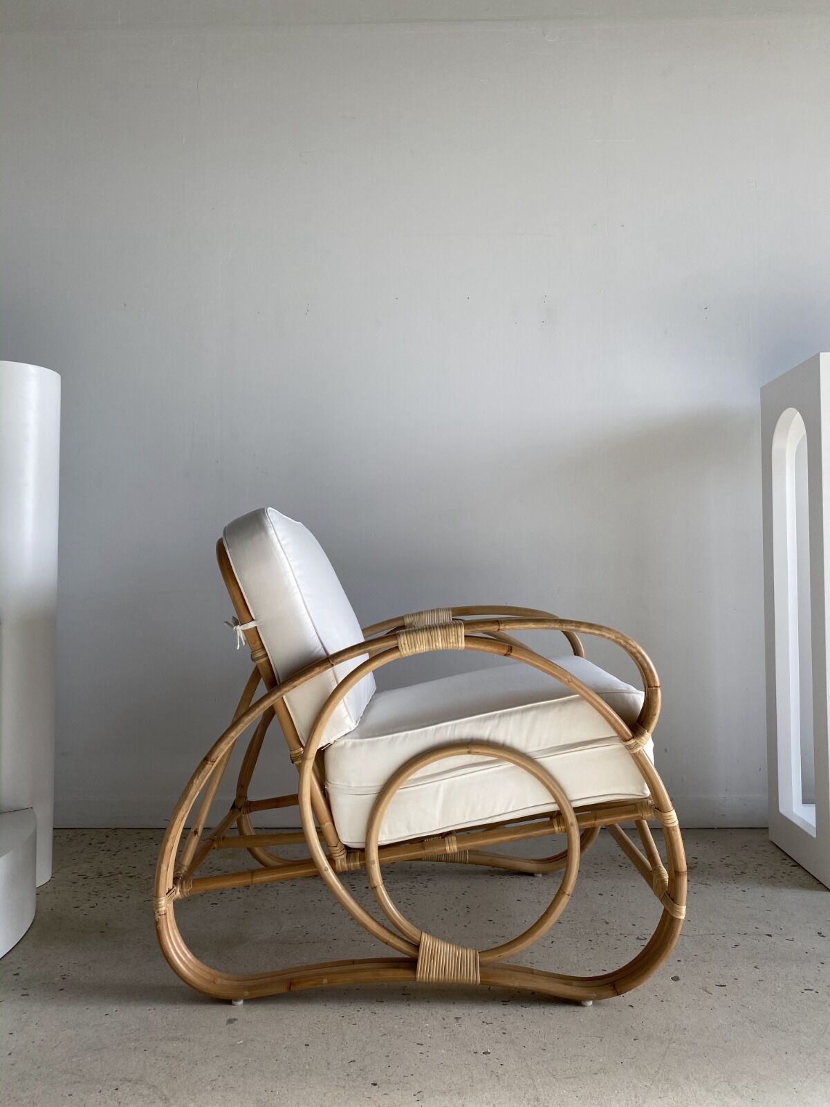 Large rattan rest chair and white cushions