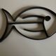 Modernist fish trivet in beaten iron, 1960.
