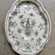 Oval Moustiers plate in cream and green earthenware, 18th century.