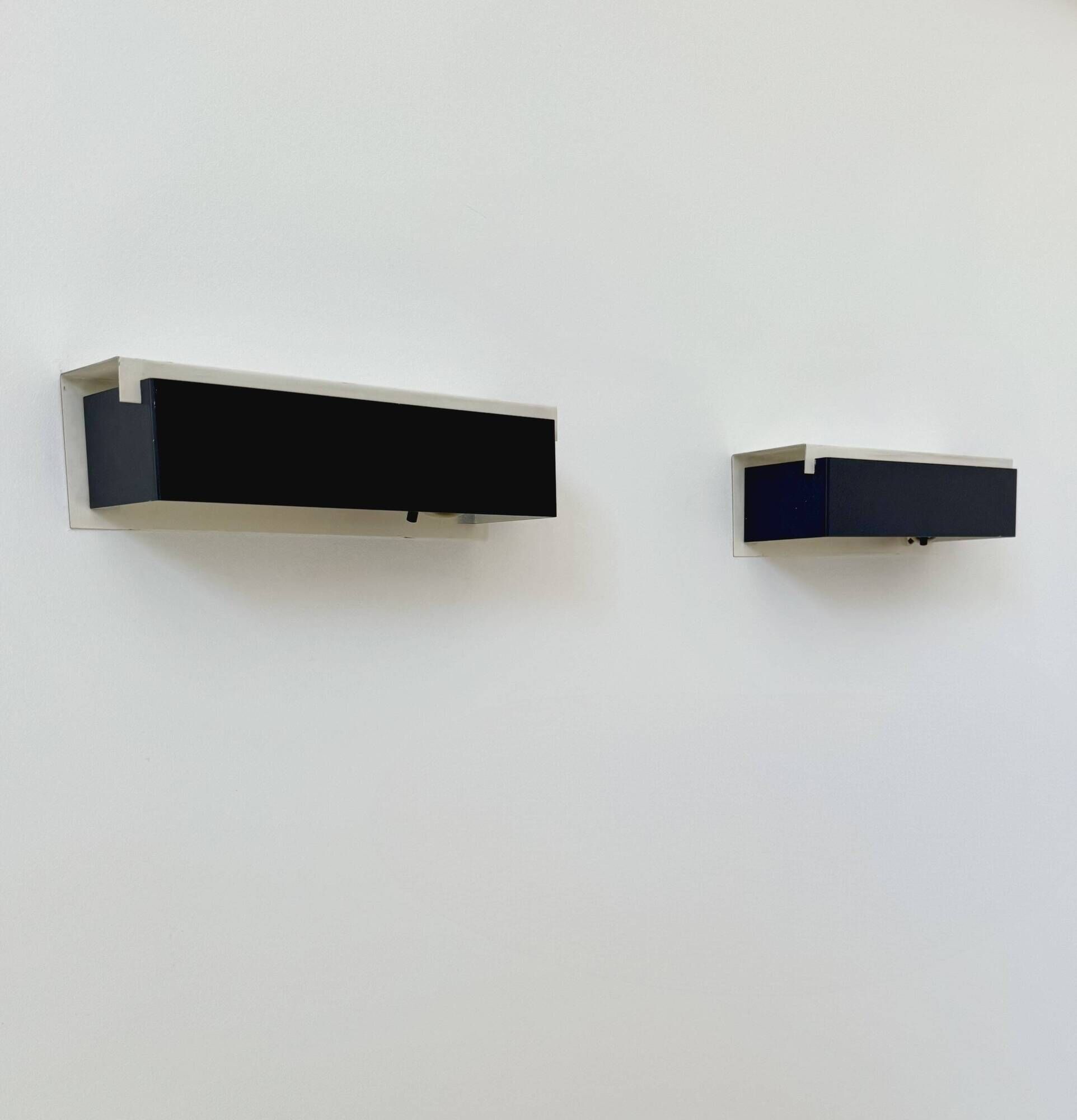 Pair of vintage wall sconces, painted black and white metal, Sweden 1970.