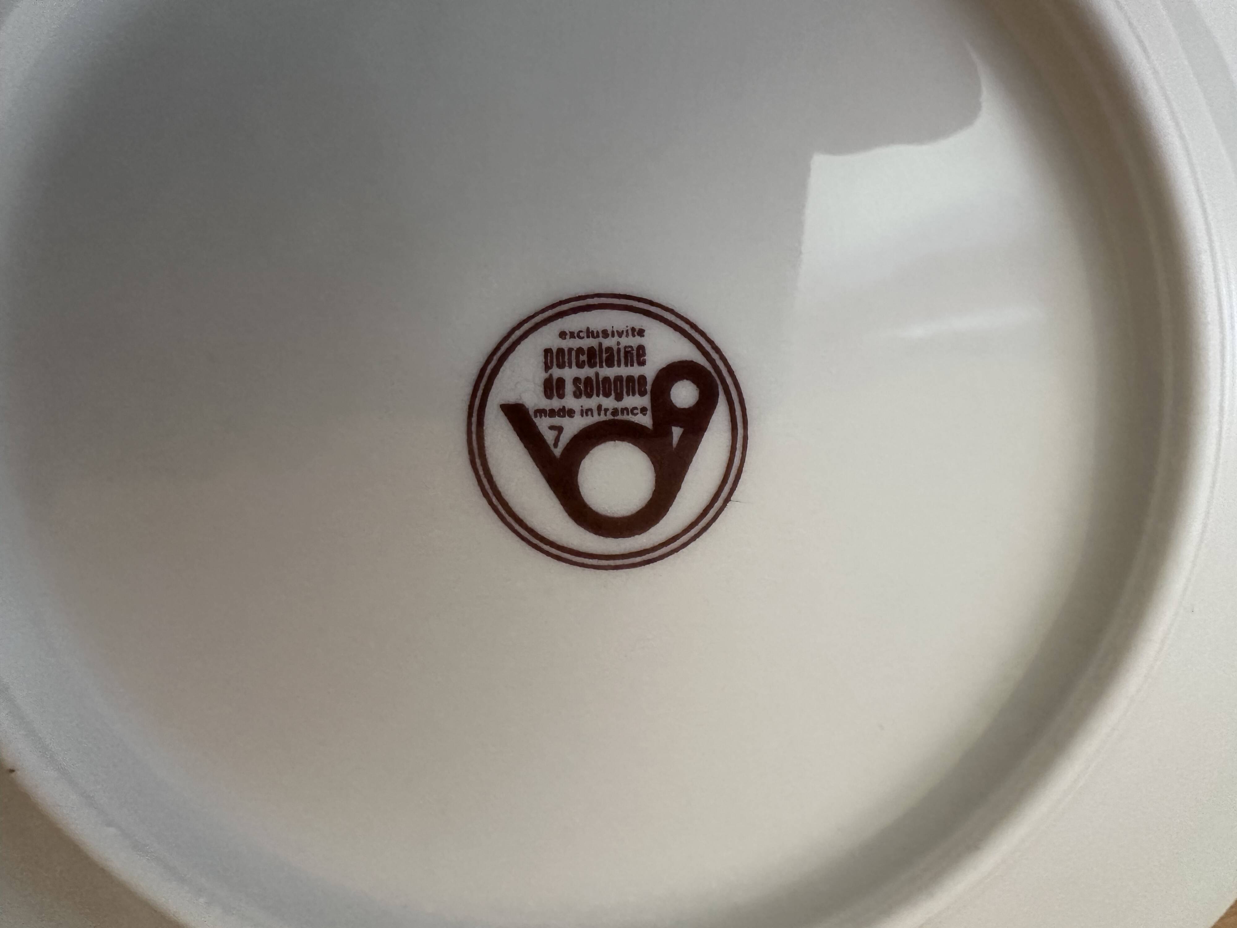 12 plates and 1 serving dish, white porcelain with apple blossom patterns.