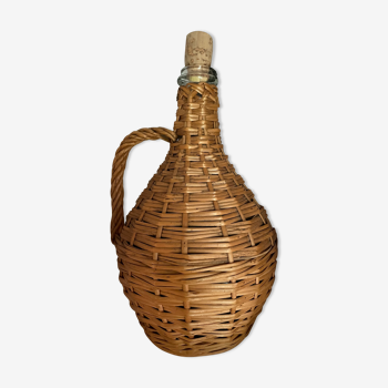 Glass bottle surrounded by wicker