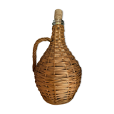 Glass bottle surrounded by wicker