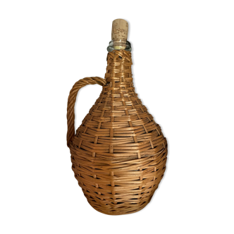 Glass bottle surrounded by wicker