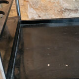 Blackened wooden rolling table