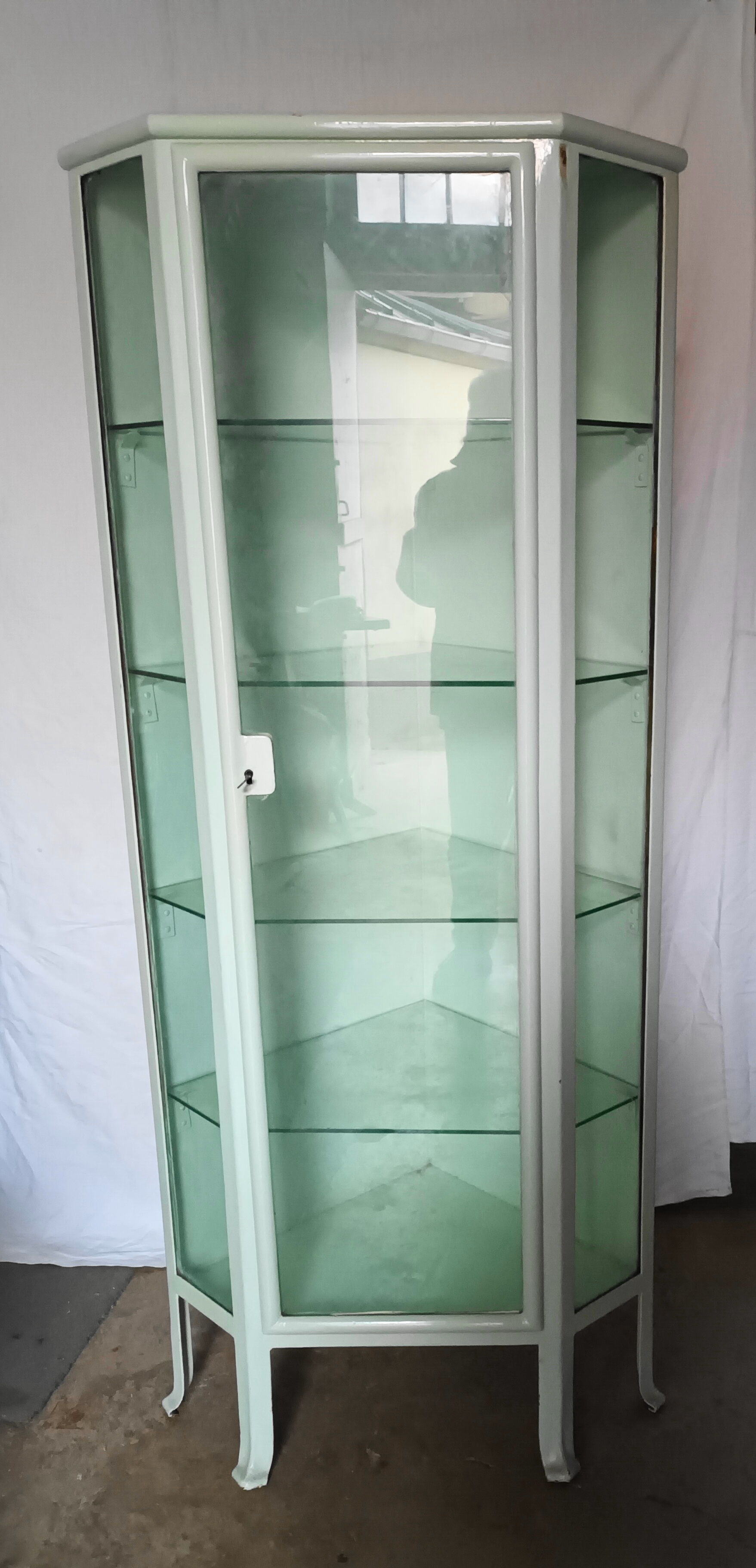 Painted metal ophthalmologist's corner display case, early 20th century