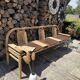 Baumann bench with wooden frame and faux leather seat.