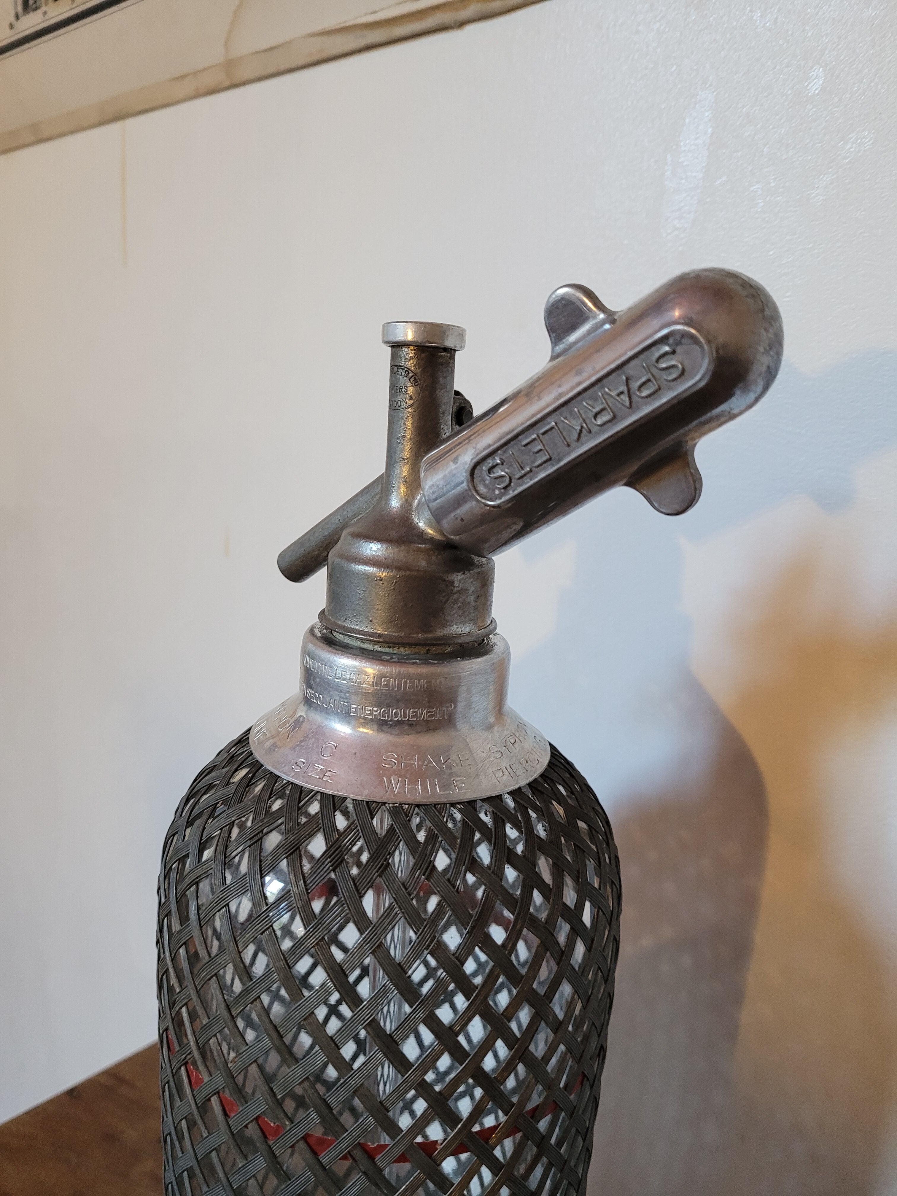 Old glass and metal siphon