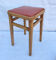 Vintage wooden stool and red skai seat