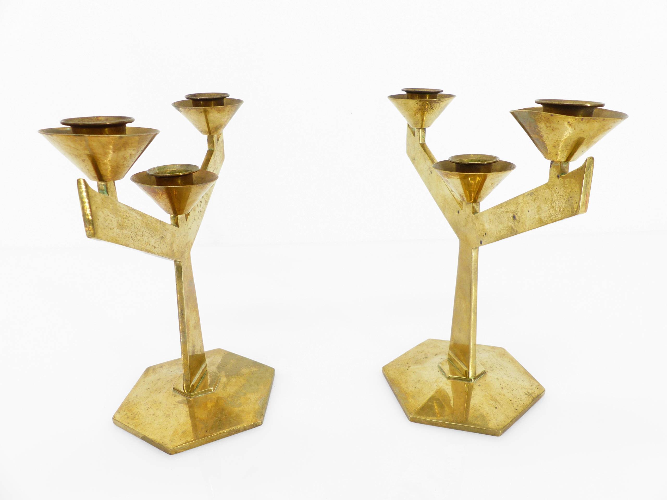 Pair of modernist three-armed solid brass candlesticks, circa 1960
