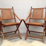 Pair of folding chairs in bamboo and caning, leather and brass
