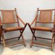 Pair of folding chairs in bamboo and caning, leather and brass