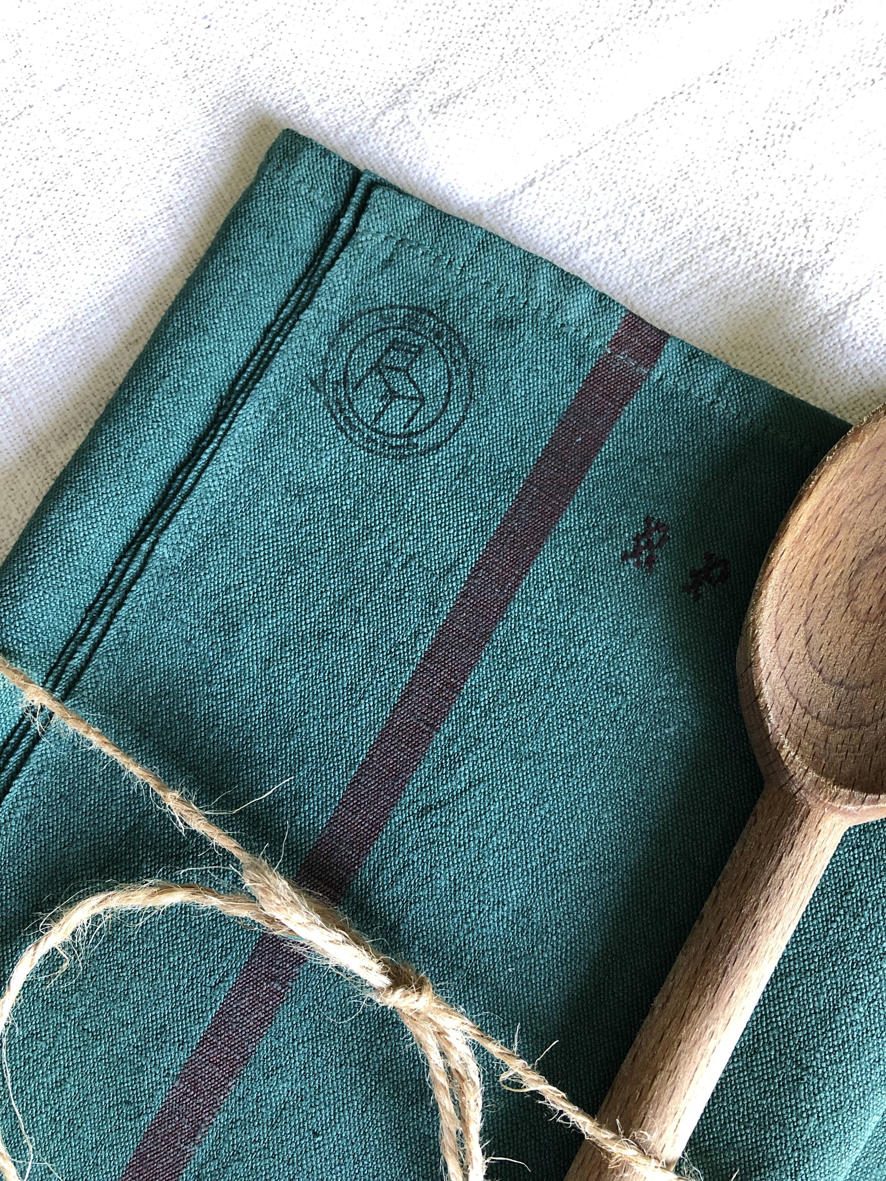 Old linen and cotton tea towel tinted in fir green