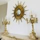 Massive gilded bronze chandeliers from the mid-20th century with marble bases.
