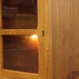 Elegant vintage Danish display cabinet with glass panels and atmospheric lighting