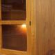 Elegant vintage Danish display cabinet with glass panels and atmospheric lighting