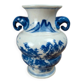 Blue and white Chinese vase with sculpted handles and landscape decoration.