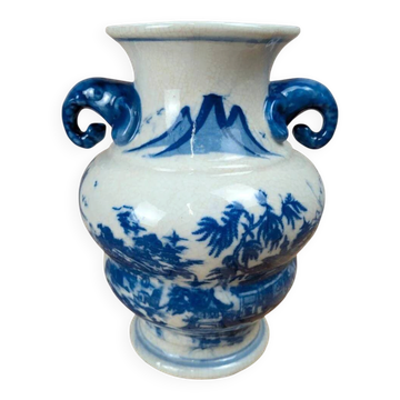 Blue and white Chinese vase with sculpted handles and landscape decoration.