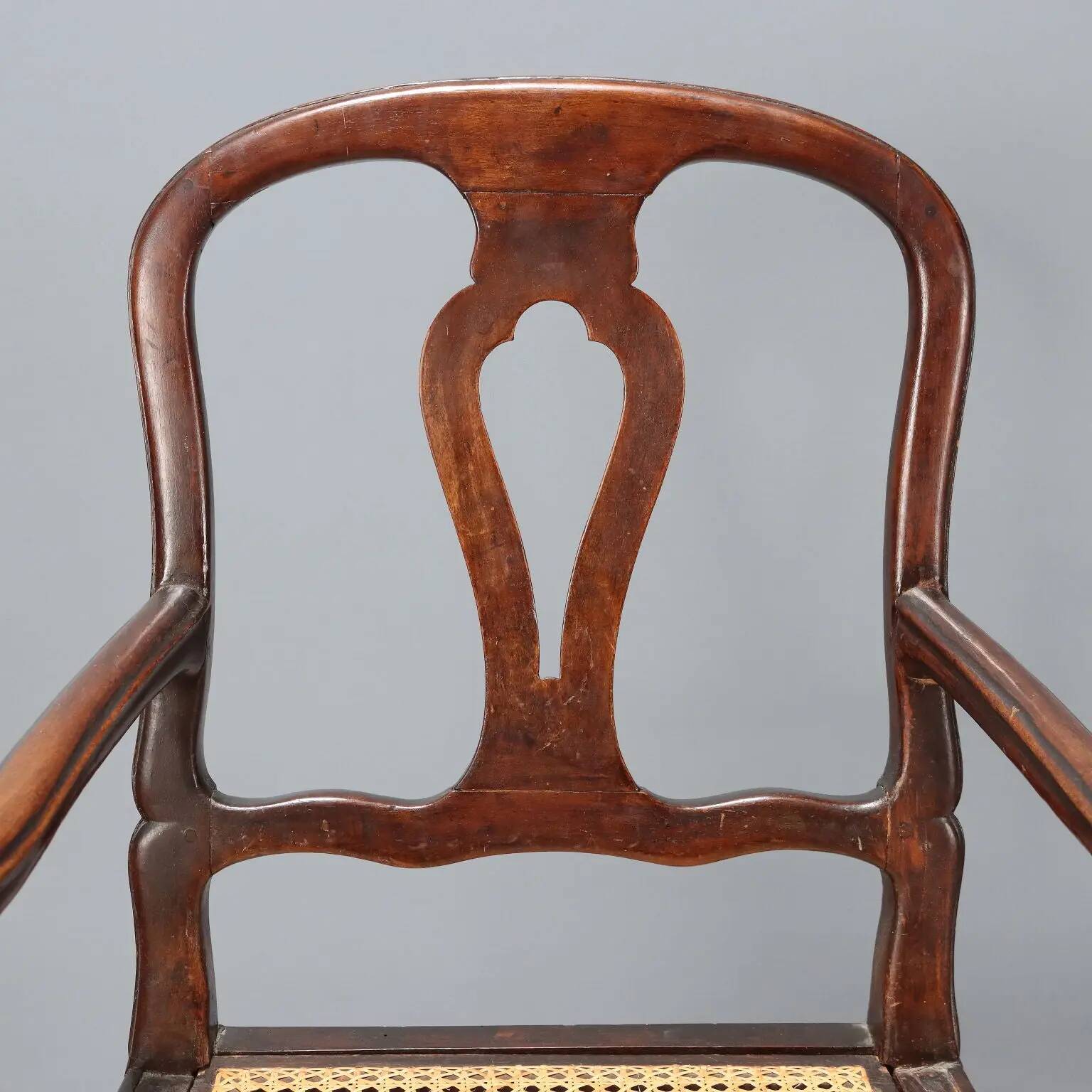 Antique walnut armchair with caned seat, Italy, 18th century