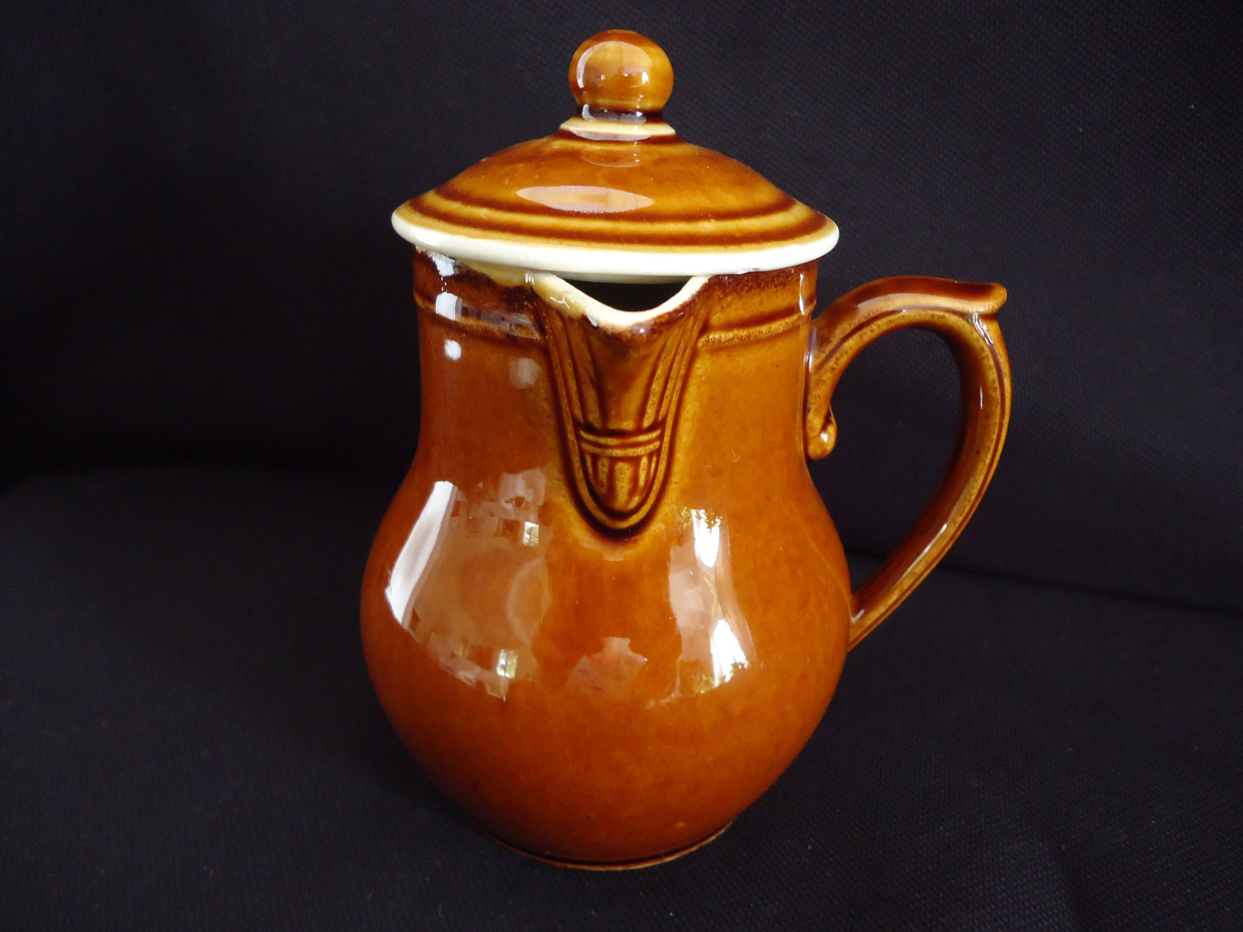 Old covered milk jug, side handle