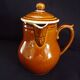 Old covered milk jug, side handle