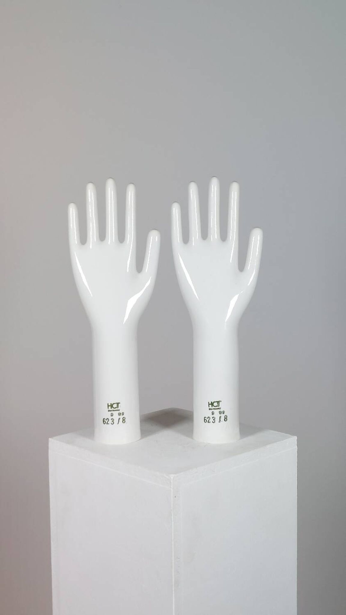 Pair of authentic vintage jewellery displays in industrial porcelain representing hands.
