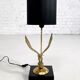 Brass lamp on black lacquered wooden base