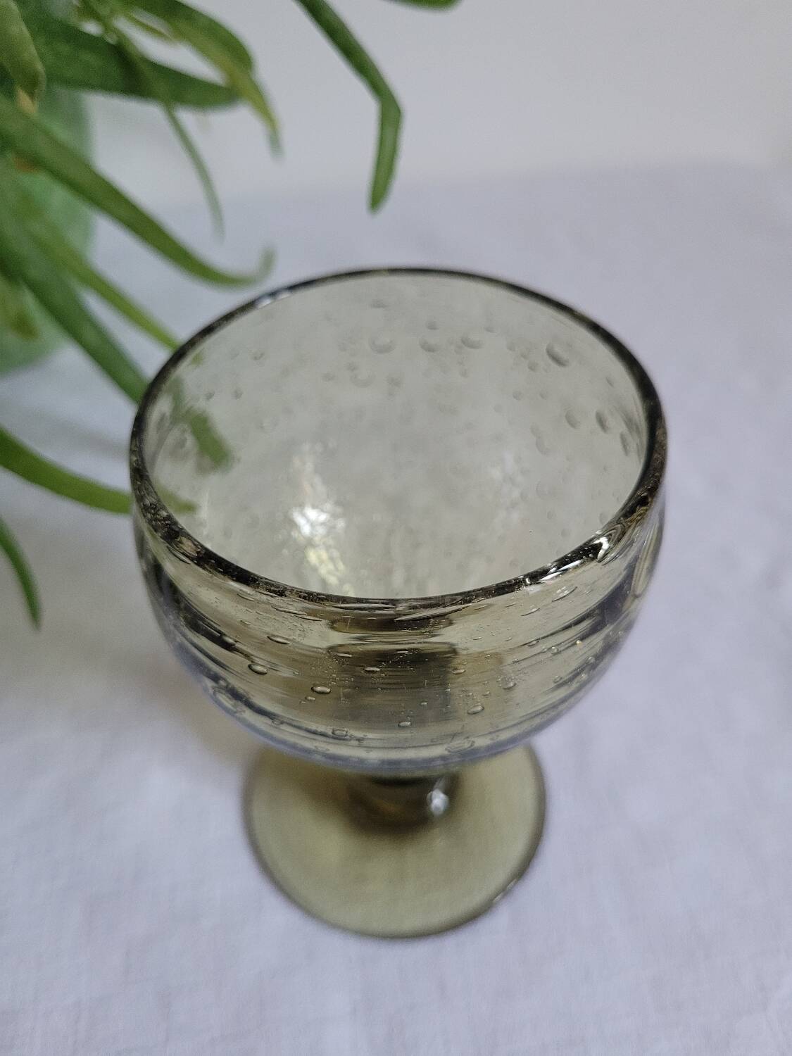 Footed glass made of blown glass