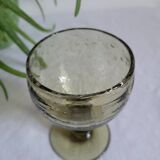 Footed glass made of blown glass