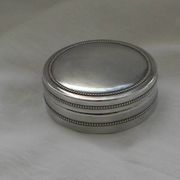 Small round silver metal box SNPA.
