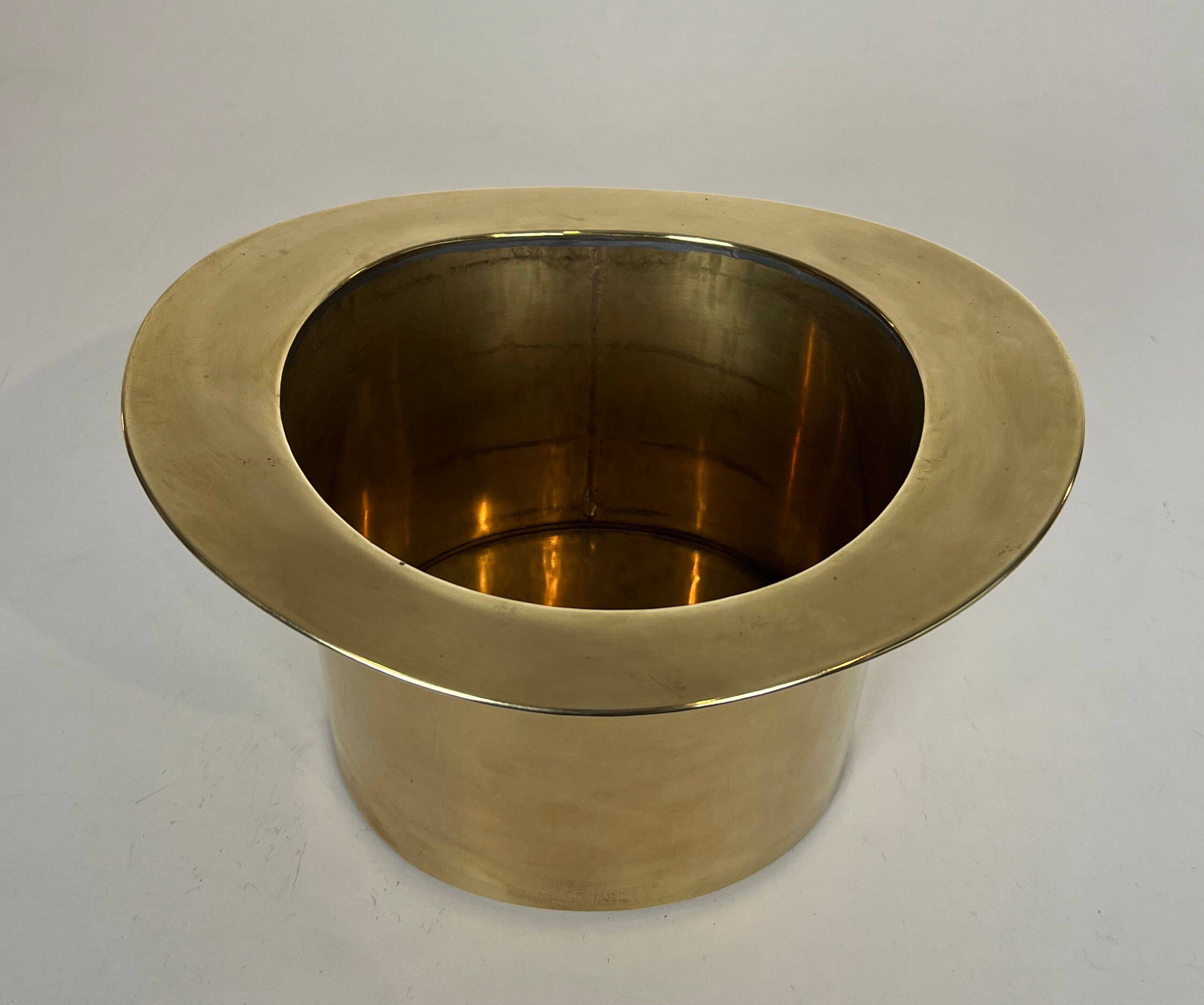 Champagne cooler shaped like a brass top hat.