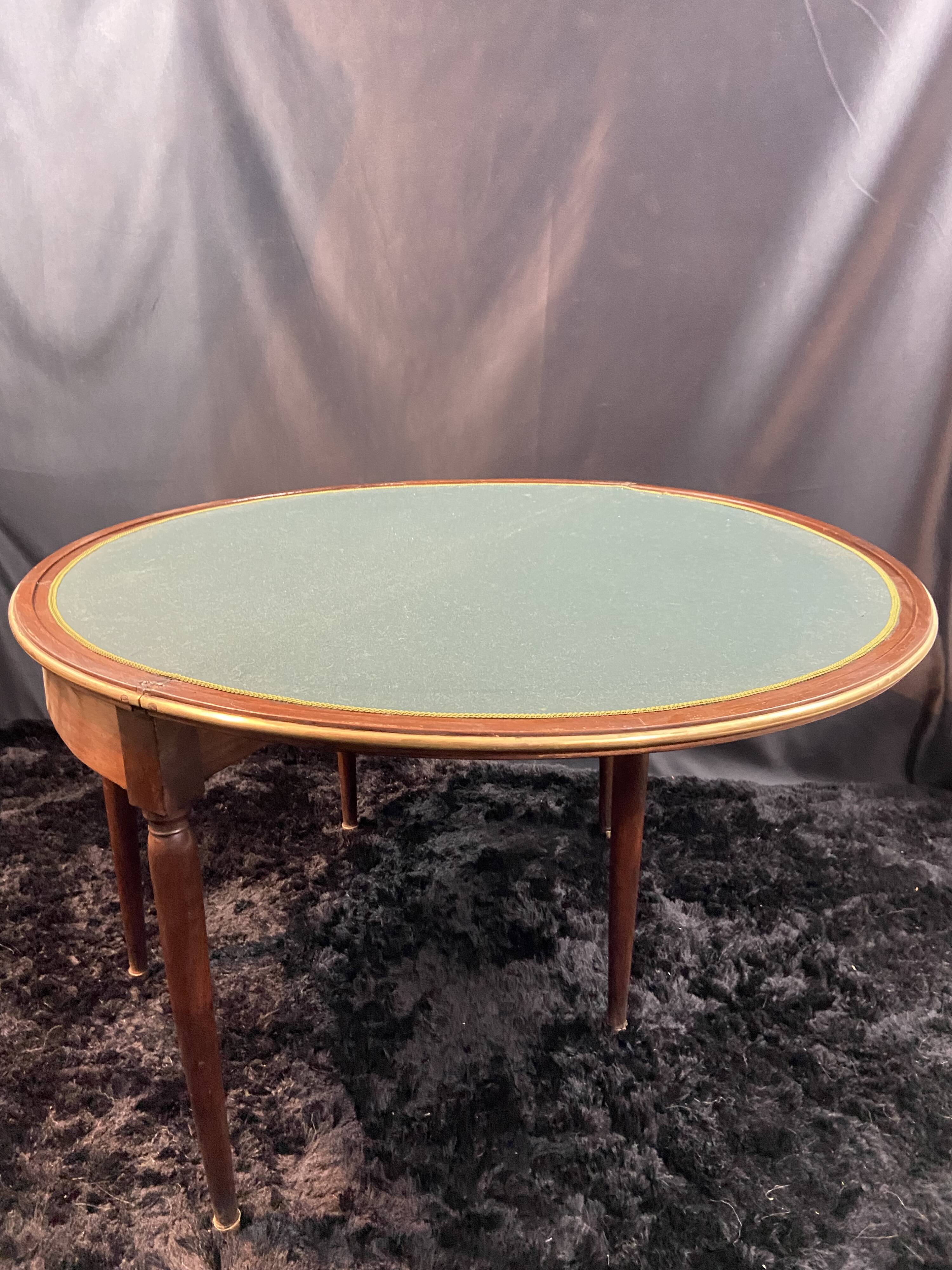 A Louis XVI period mahogany half-moon table forming a console/games table