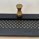 Coat rack in black lacquered metal, perforated sheet metal and brass in the style of Mathieu Matégot