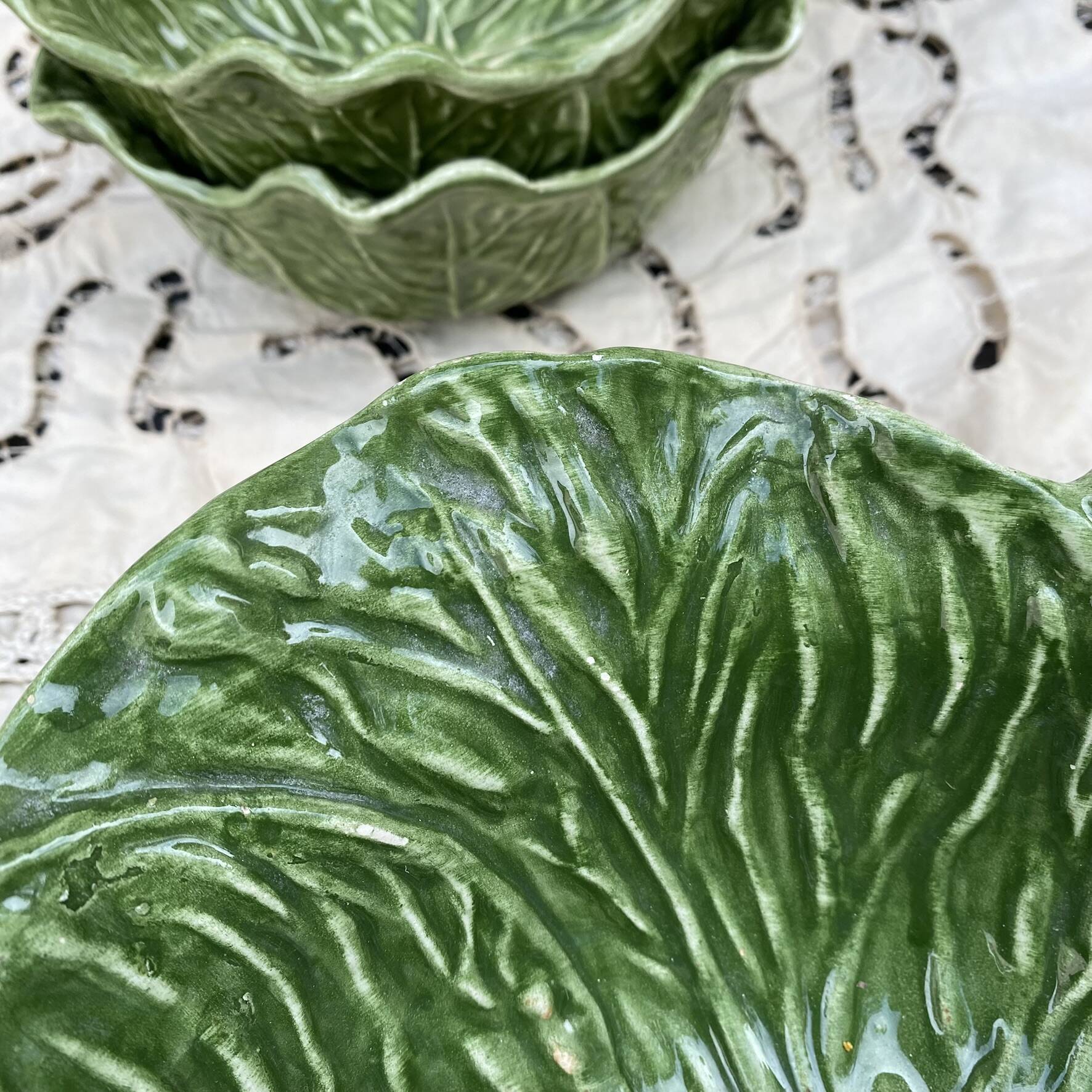Large earthenware salad bowl in the shape of a cabbage leaf.