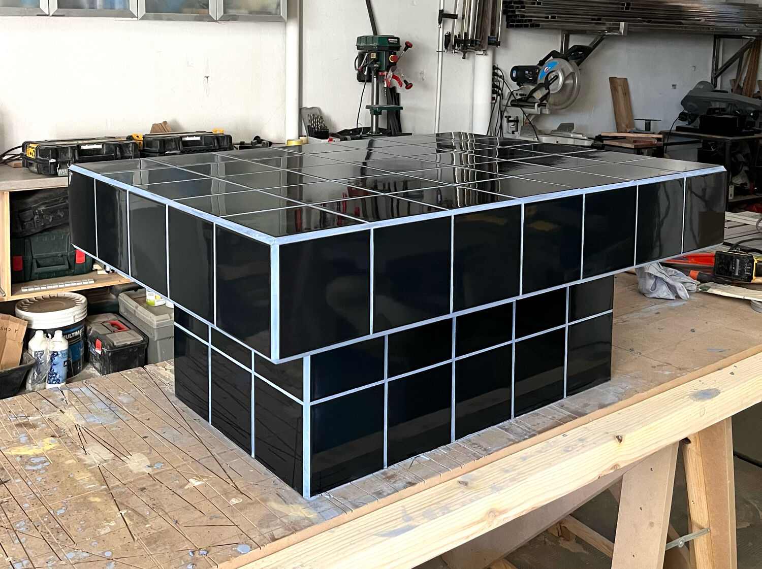 Black tiled coffee table and midnight blue grout