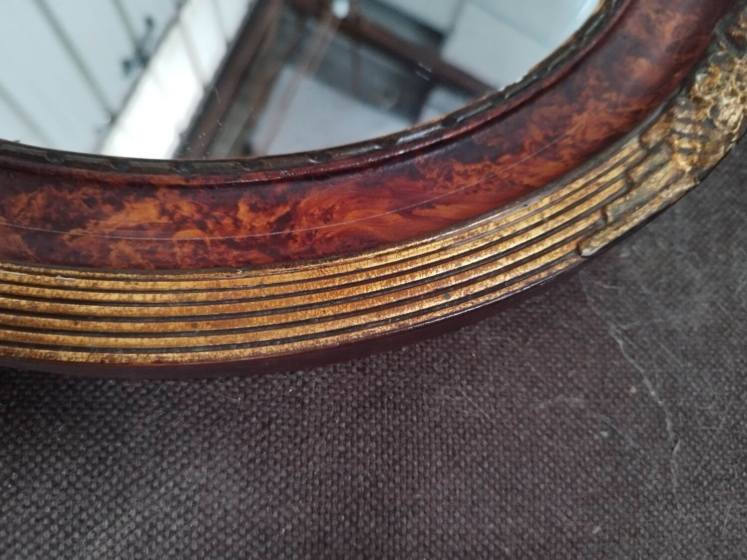 Golden oval art deco mirror