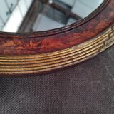 Golden oval art deco mirror