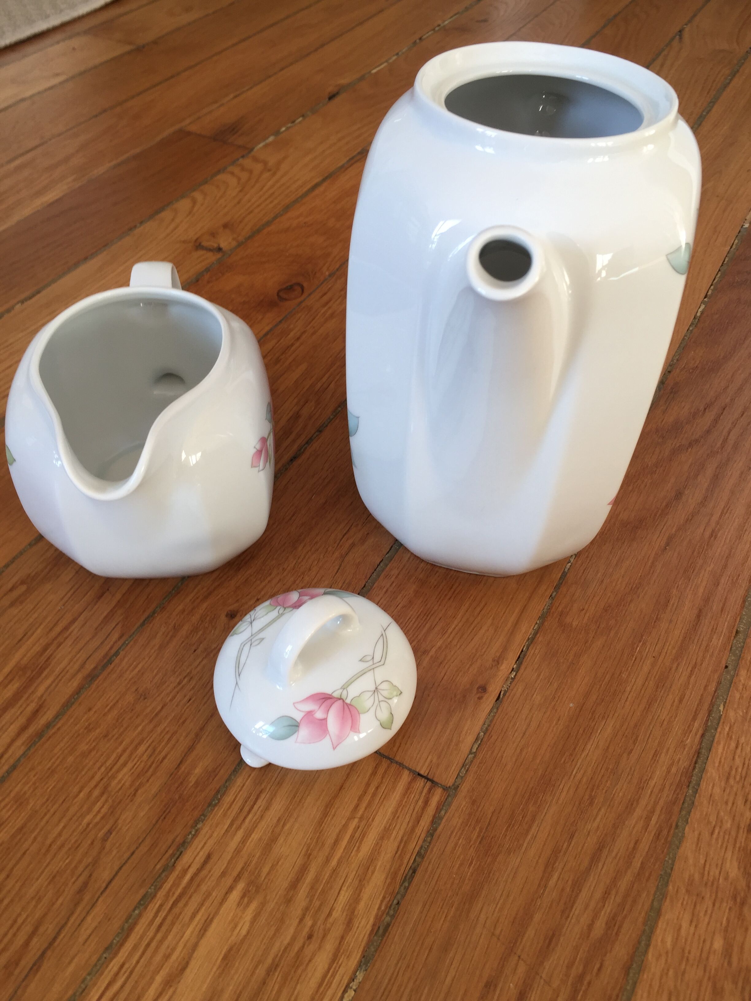 Vintage porcelain coffee or teapot with milk jug