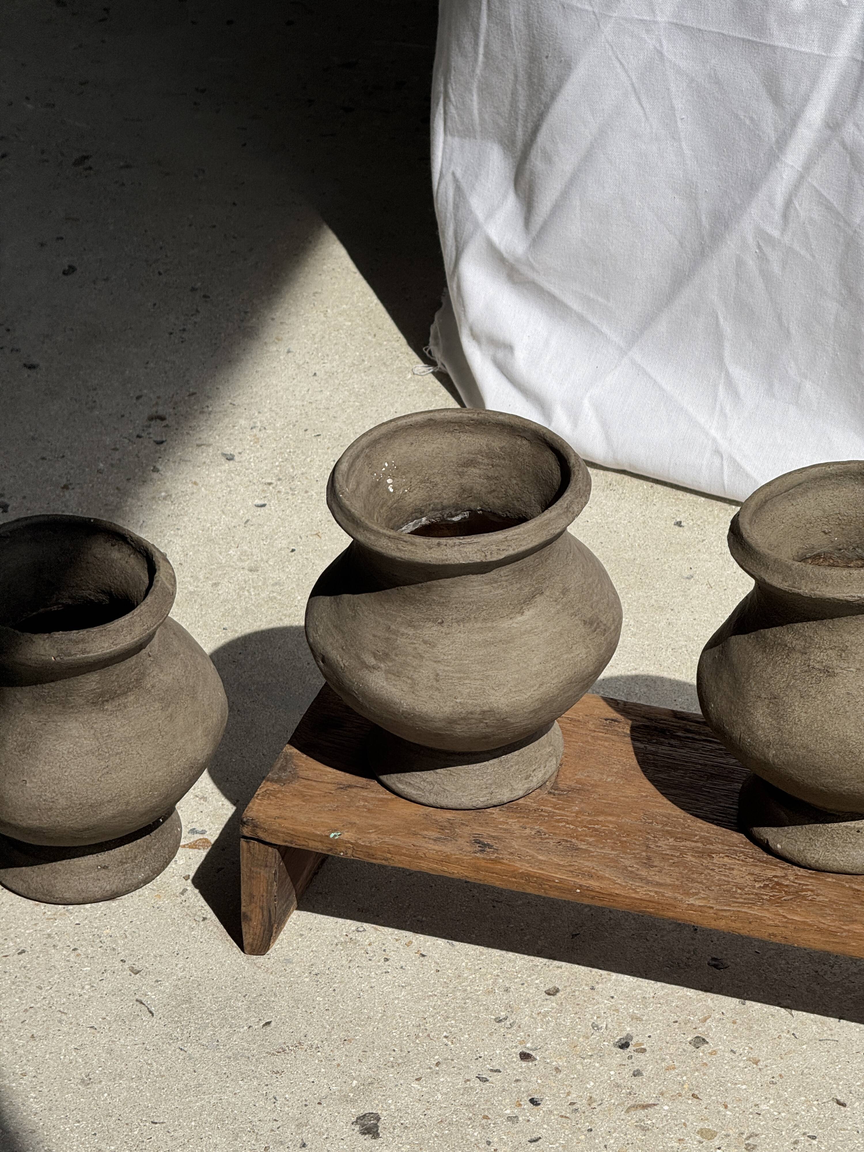 Small brutalist handcrafted terracotta vase with a pedestal, Indonesian, H19 D17.