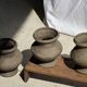 Small brutalist handcrafted terracotta vase with a pedestal, Indonesian, H19 D17.