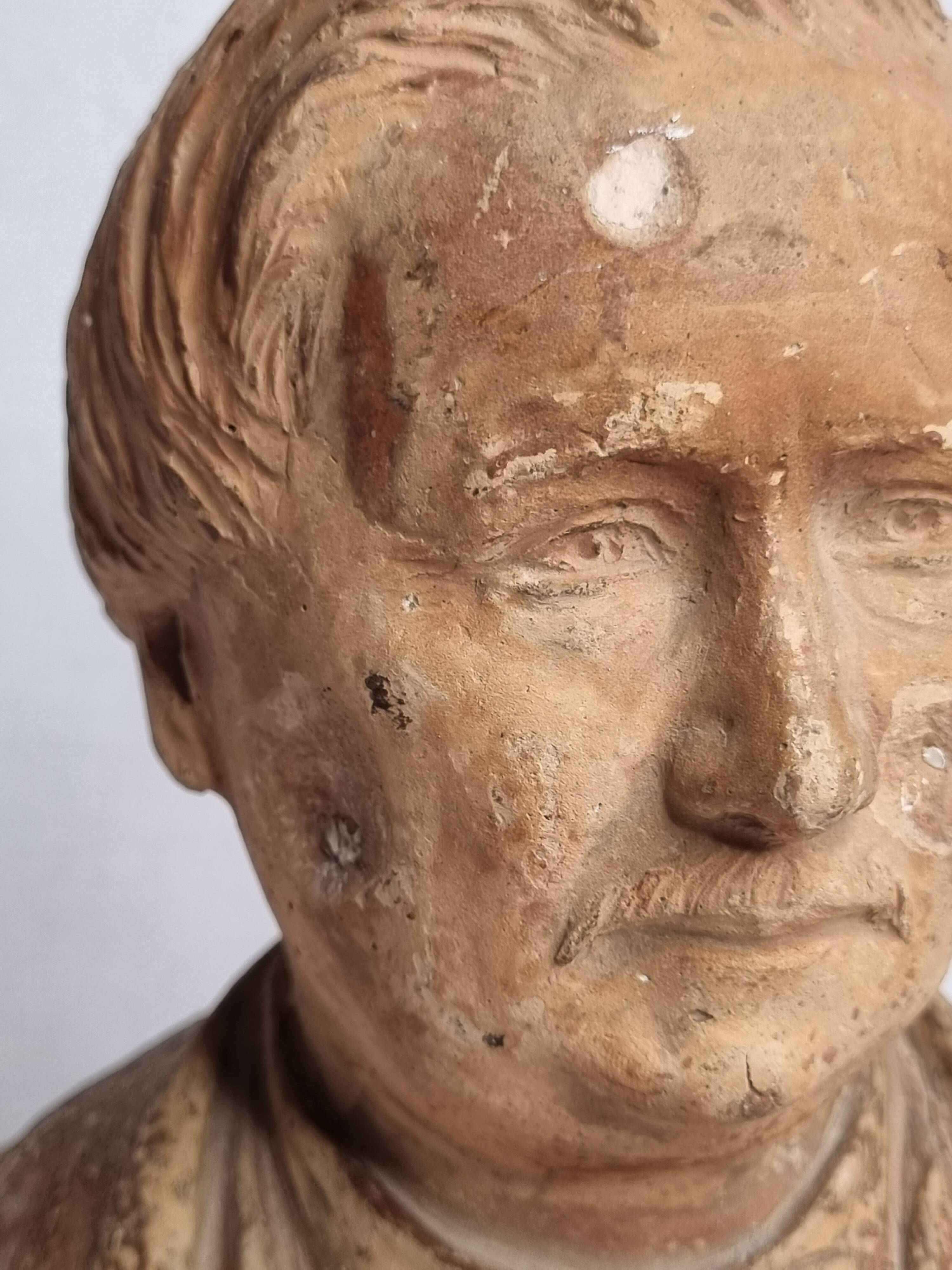 Bust of a notable in terracotta, 29 cm, signed Pasquet, 1870, on a base.