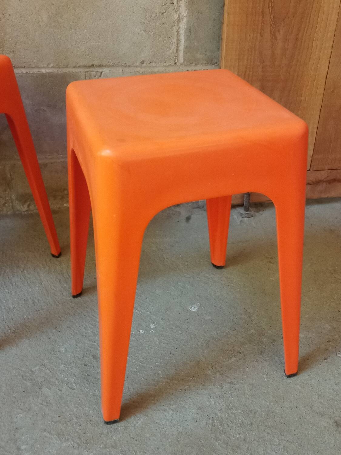 Pair of AMI stools in orange plastic