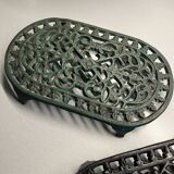 Duo of antique cast iron table mats