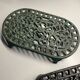 Duo of antique cast iron table mats