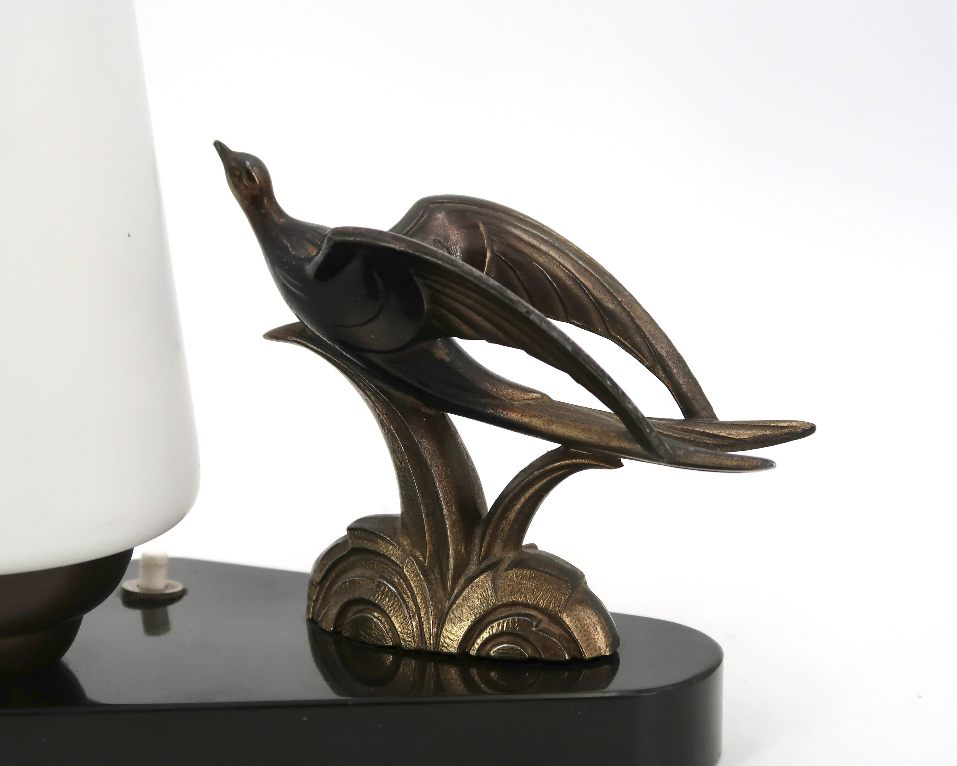 Art Deco lamp with swallow sculpture, marble base, opaque white globe.
