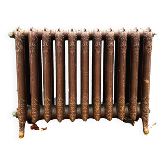 Old radiator on feet with flowered blades in cast iron 20th century