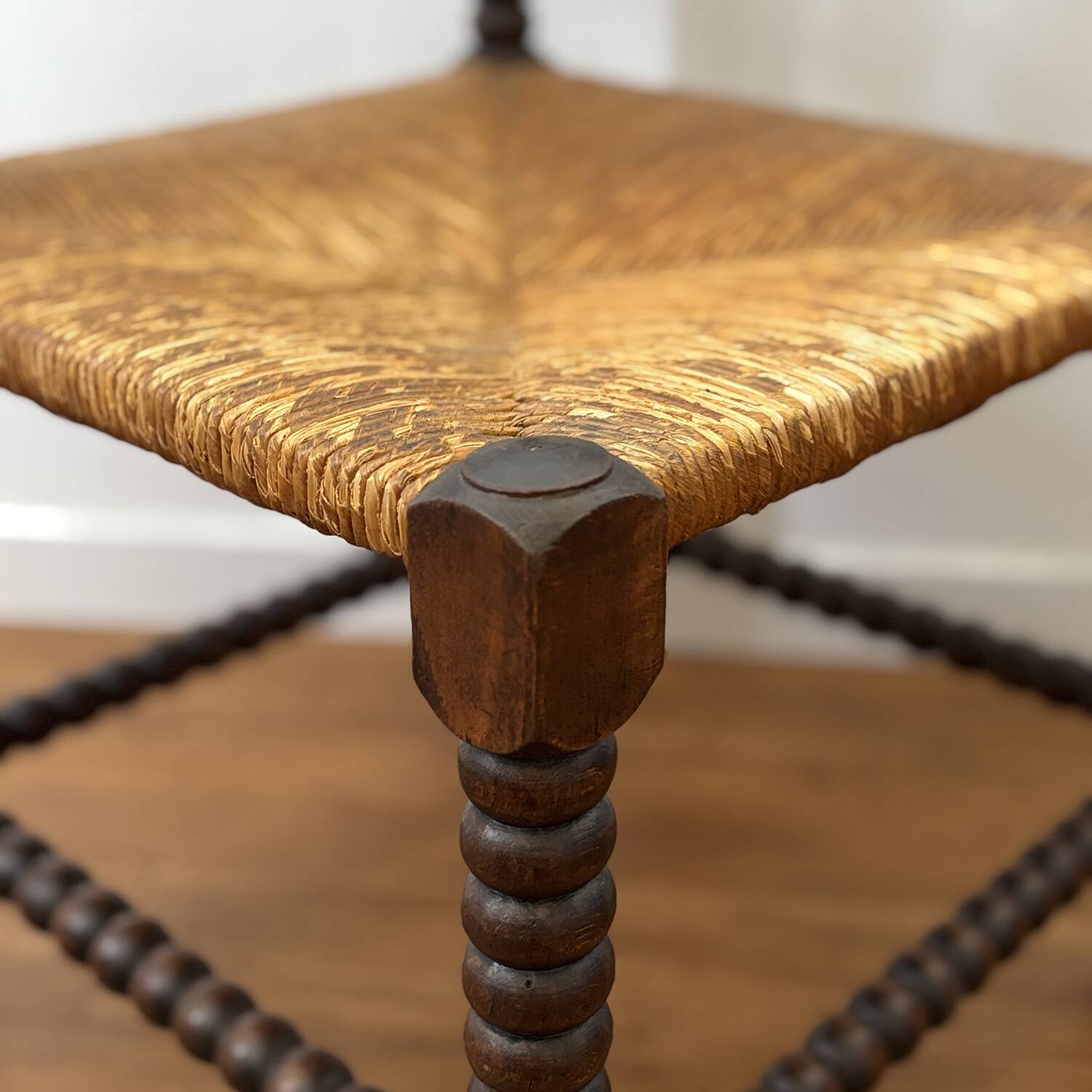 Turned wood corner chair with straw seat