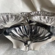Set of 12 stainless steel scallop shells, 1970s-80s.