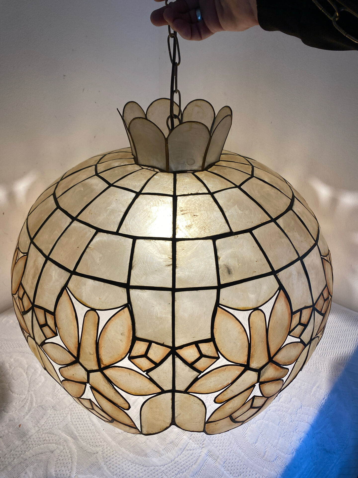 Large mother-of-pearl and brass chandelier with floral decoration.